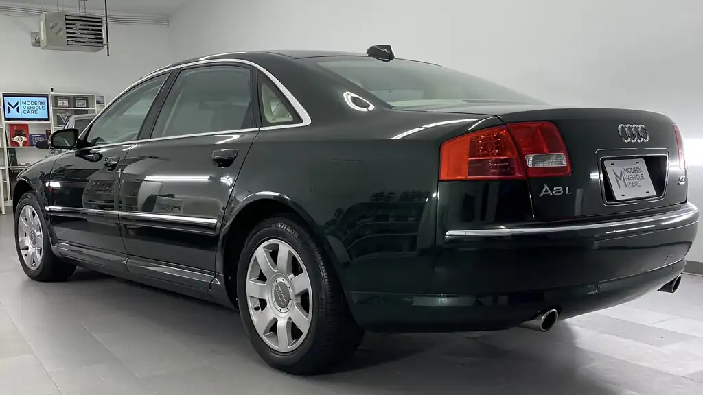 Dark green Audi A8L in the white studio bay
