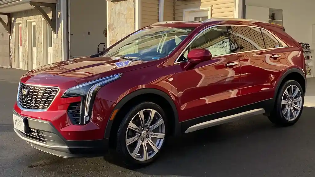 Red Cadillac XT4 with a deep gloss outside the shop